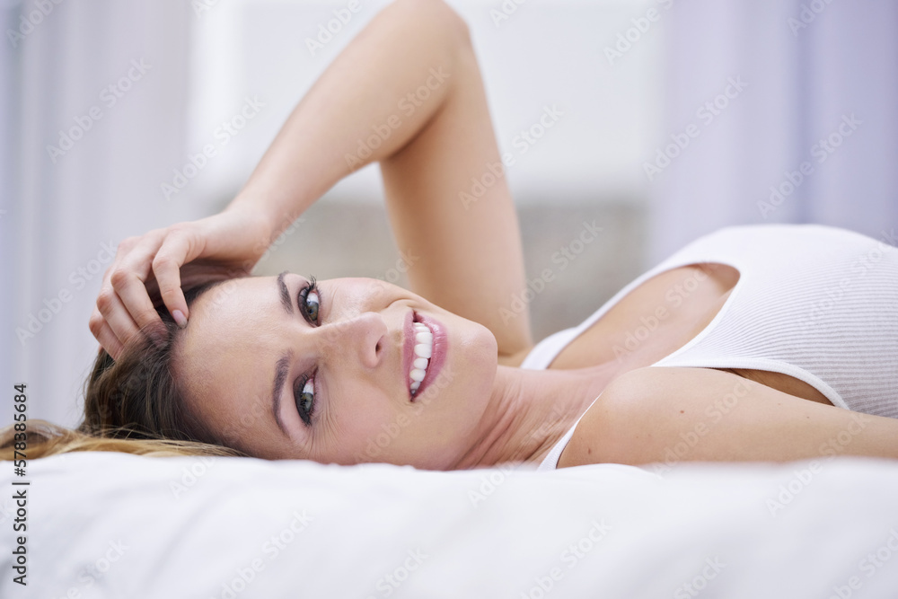 Having a lazy weekend. Portrait of a beautiful woman lying on her bed. Having a lazy weekend. Portrait of a beautiful woman lying on her bed.