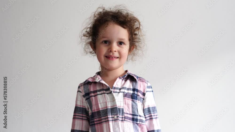 Funny little girl smiling child looking at camera at home, happy childhood Funny little girl smiling child looking at camera at home, happy childhood