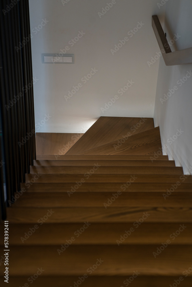 Fototapeta premium Illuminated staircase to the second floor