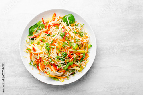 Fresh Vegetable Salad with Cabbage, Bell Pepper, and Carrot on Bright Background, Healthy Eating
