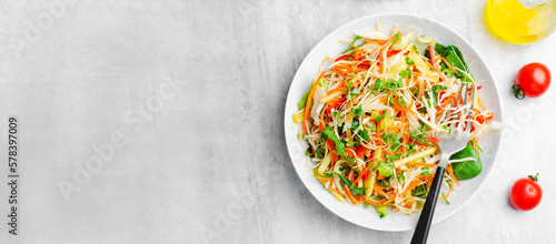Fresh Vegetable Salad with Cabbage, Bell Pepper, and Carrot on Bright Background, Healthy Eating