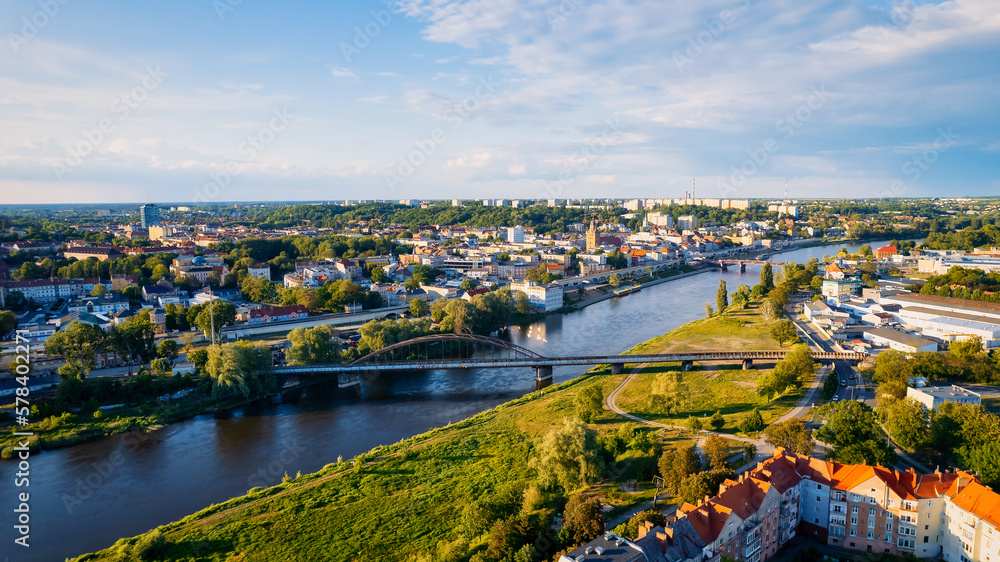 In Gorzów Wielkopolski, a drone photo was taken on a sunny day featuring the River Warta, the Cathedral, and the city center