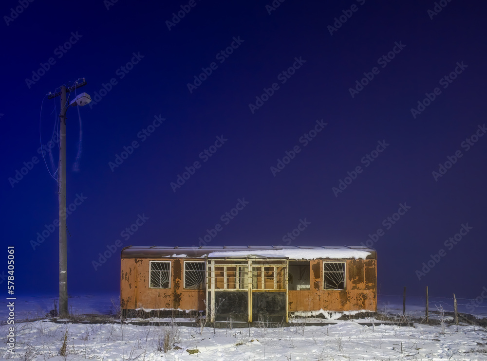 abandoned wagon change house at night in the fog in winter