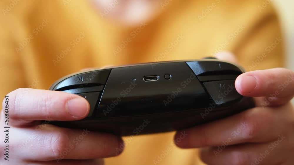 Woman hands holding black joystick gamepad playing game console. Computer gaming competition videogame control concept. Using controller playing video games. Cyberspace symbol. Hands joypad close up Woman hands holding black joystick gamepad playing game console. Computer gaming competition videogame control concept. Using controller playing video games. Cyberspace symbol. Hands joypad close up