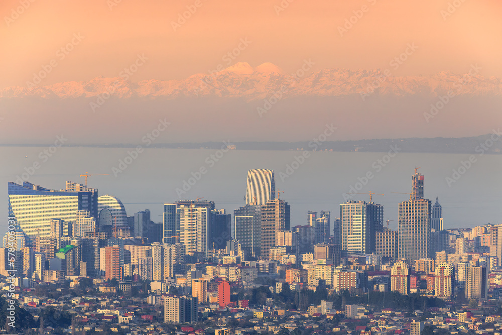 the city of batumi against the backdrop of the caucasian mountains at sunset