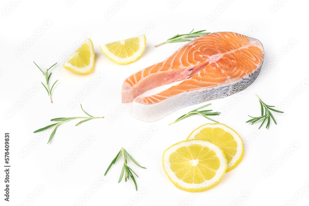 Fresh raw salmon slices with lemon and rosemary arranged on a white background. Healthy seafood food. Top view. Fresh raw salmon slices with lemon and rosemary arranged on a white background. Healthy seafood food. Top view.
