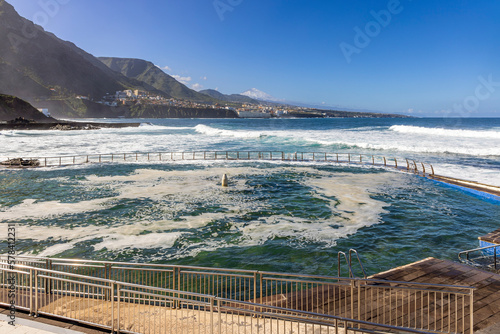 sea-water swimming pool at Punta del Hidalgo in Tenerife with the coastal town of Bajamar and Mount Teide in the background. photo