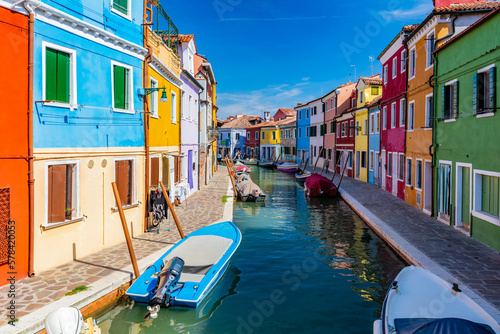 Burano, Italy with colorful painted houses along canal with boats © Photocreo Bednarek