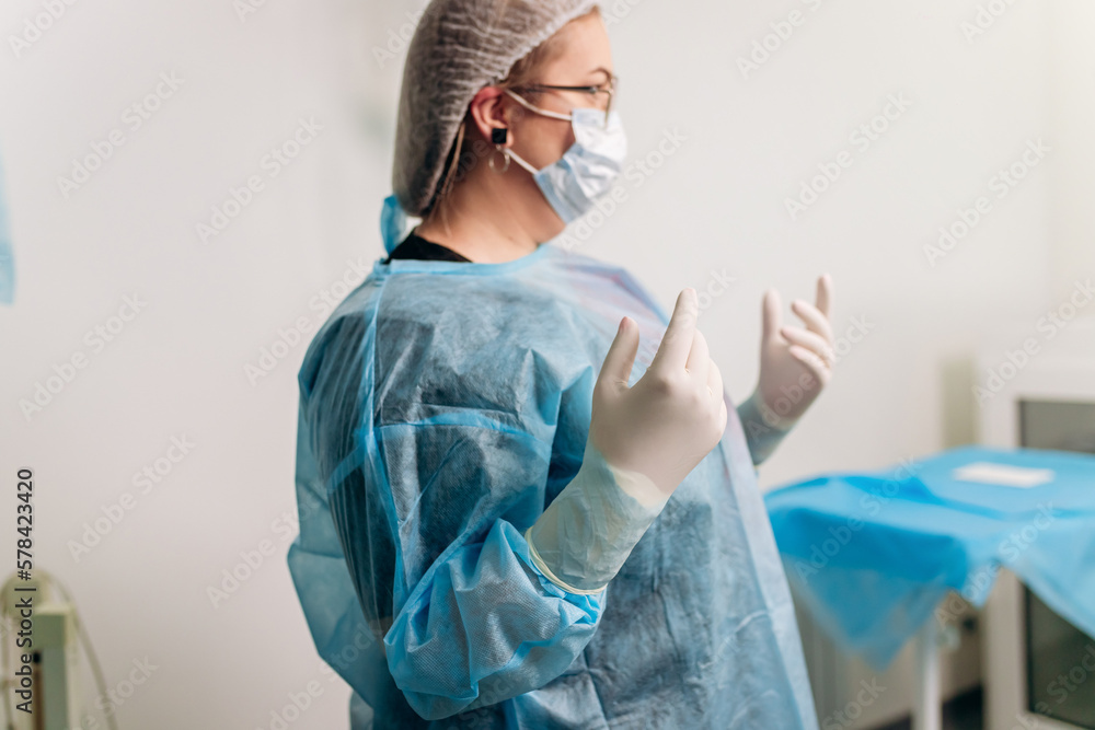 Doctor preparation for surgical operation in hospital. Medical workers getting ready for fighting against coronavirus pandemic - Healthcare medicine concept