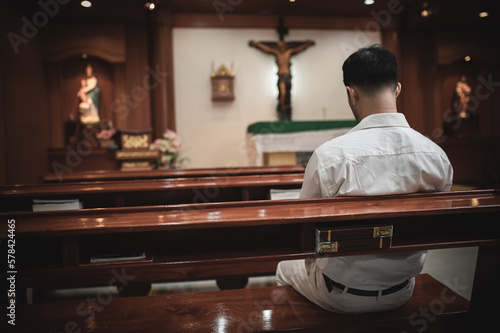 Fototapeta Christian man asking for blessings from God,Asian man praying to Jesus Christ