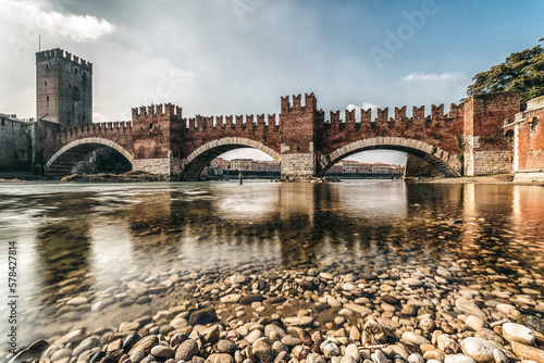 Roman arch bridge Ponte Pietra over Adige river in city Verona, Italy