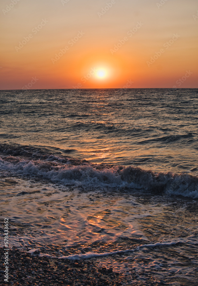 Obraz premium Sunset over Mediterranean Sea seen from a beach at Rhodes island