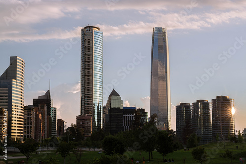 sunset at the bicentennial park with a view of the costanera center and the titanium tower in santiago de chile