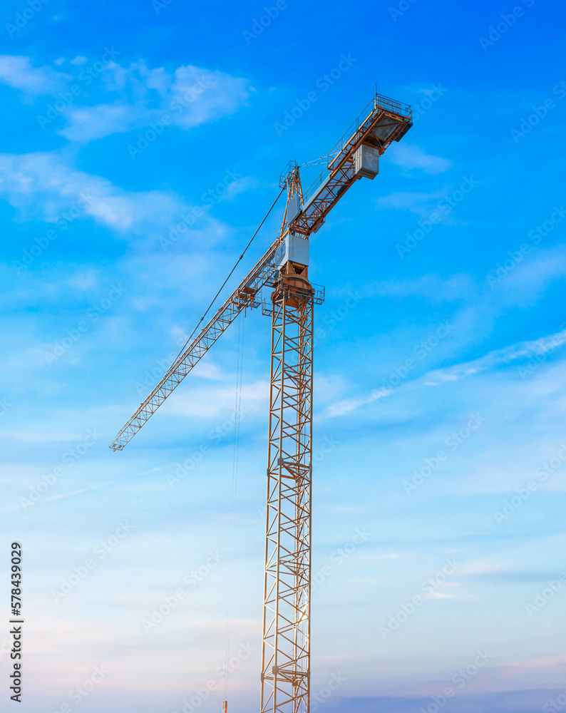 Construction tower crane against the blue sky.