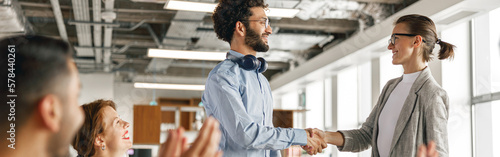 Photos Smiling female boss leader shaking hand of new team member recruiting him for jo
