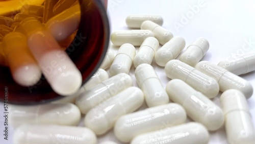 Antibiotic capsule pills on white background.