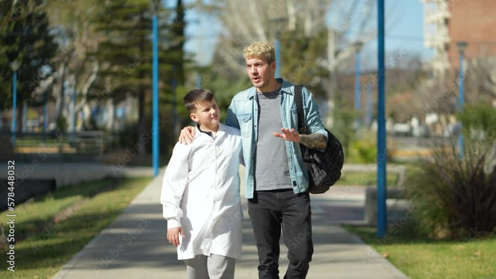 Father and son talking while going to school in Argentina Father and son talking while going to school in Argentina