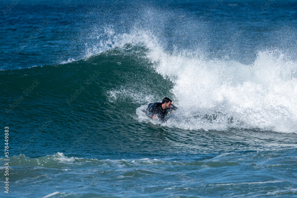 Bodyboarder surfing ocean wave