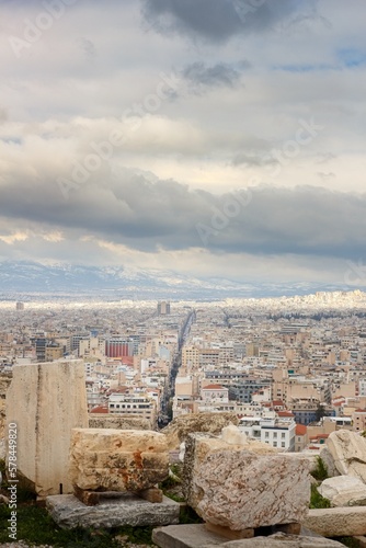 View on Athens streets from Pantheon on winter during cloudy cold day with snow on the mountain in background