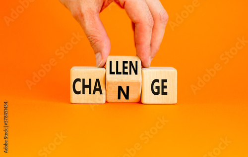 Challenge and change symbol. Concept word Challenge Change on wooden cubes. Businessman hand. Beautiful orange table orange background. Business and challenge and change concept. Copy space.