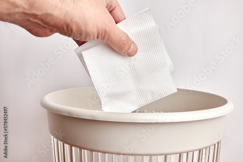 Paper napkins are thrown into the trash. Paper disposal and recycling.