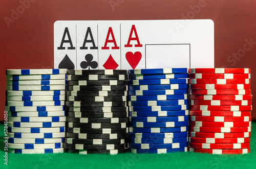 Four ace cards on the background of poker chips in a casino