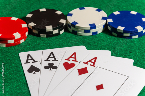 Four ace cards on the background of poker chips in a casino
