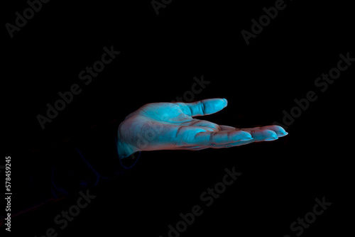 Close up of female hand with palm up receiving or holding something over black background, free space