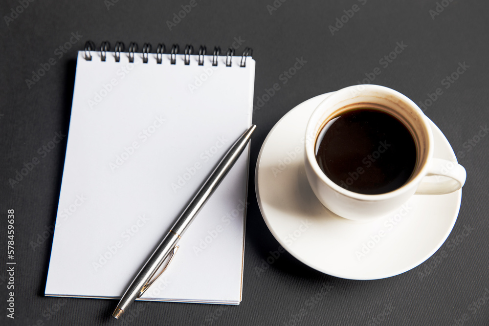 Coffee and notebook on the table