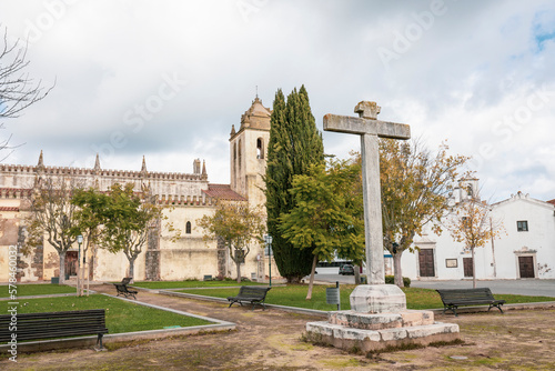 Christian Cross at the garden of the church square including the Church of Our Lady of the Assumption in Alvito town, Beja, Alentejo, Portugal - December 2022 photo
