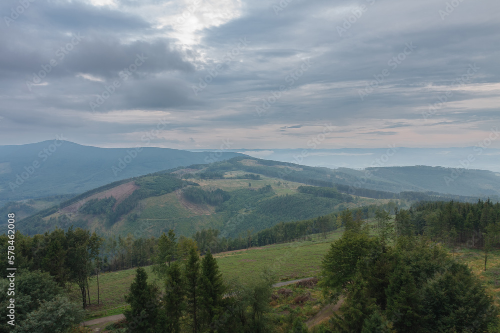 Obraz premium View from lookout tower Velky Javornik to Beskid Mountains in summer cloudy evening