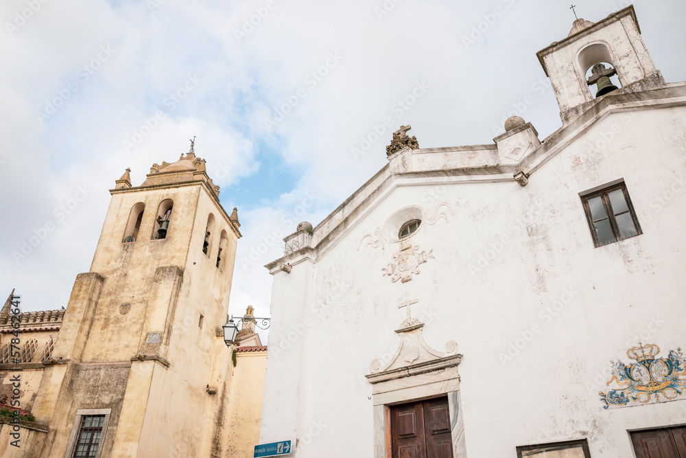 Church of Our Lady of the Assumption (left) and Church of Mercy (right) in Alvito town, district of Beja, Alentejo, Portugal - December 2022