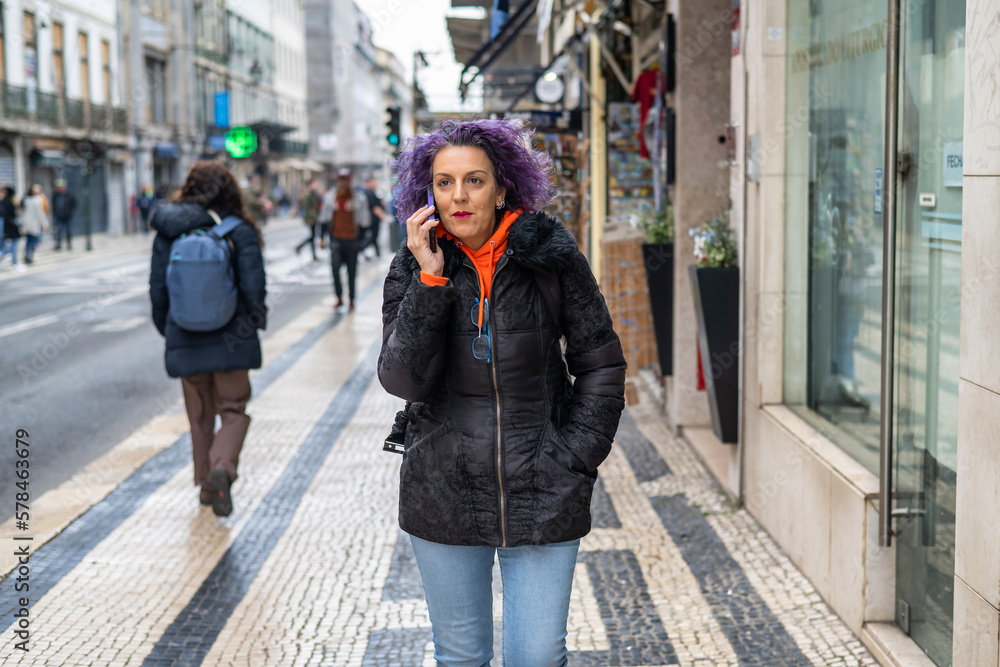 Tourist Woman Using Phone Walking Down The Street.