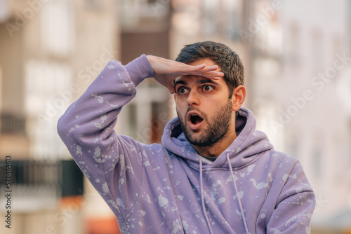 young man on the street looking surprised