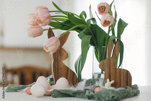 Canvas Print Happy Easter! Beautiful tulips, natural eggs and bunny decoration on modern table