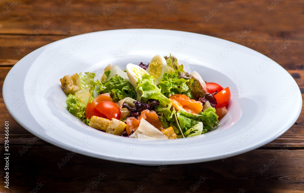 Salad with salmon and vegetables in a white plate Salad with salmon and vegetables in a white plate