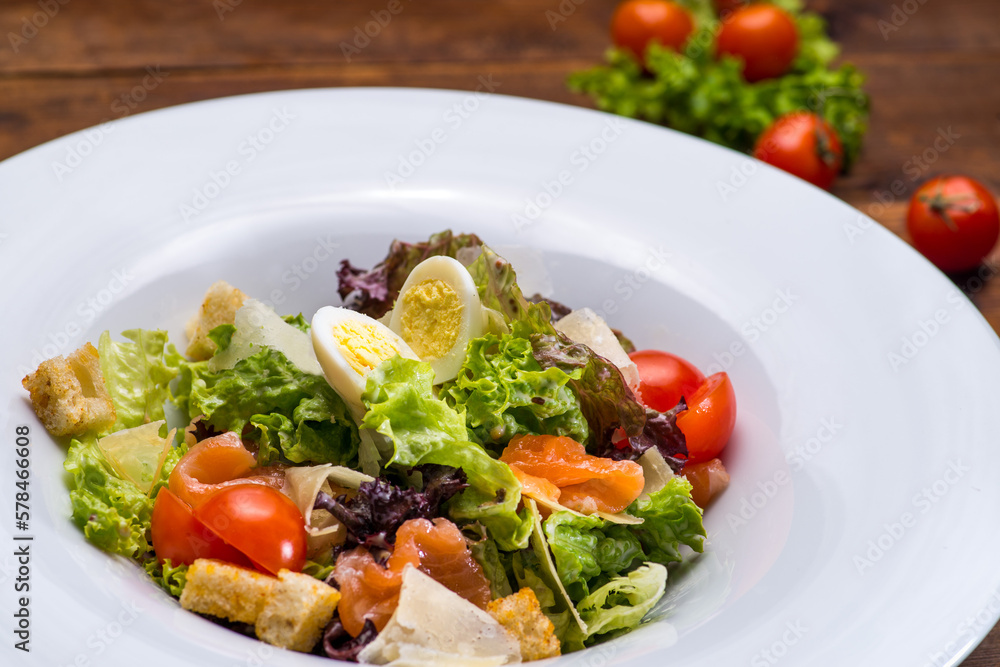 Salad with salmon and vegetables in a white plate Salad with salmon and vegetables in a white plate