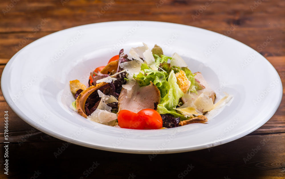 Salad with salmon and vegetables in a white plate