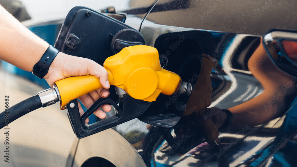 Man Refill and filling Oil Gas Fuel at station. Gas station refueling