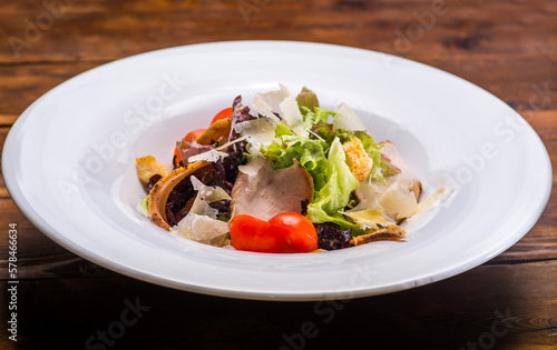 Salad with salmon and vegetables in a white plate