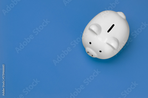 White piggy bank viewed from the top on blue background