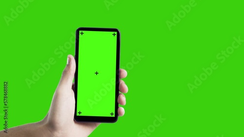 Hand holding smartphone with green screen. Mobile phone with chroma key. smartphone concept. app concept.