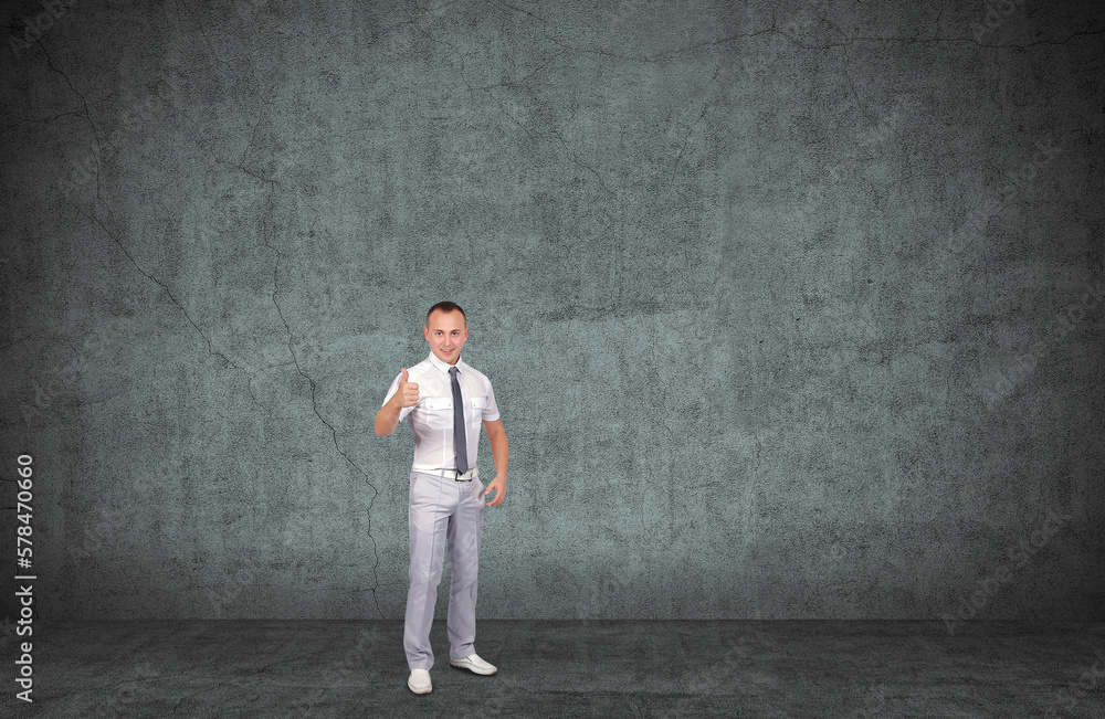 Young smiling businessman showing thumbs up sign. Young smiling businessman showing thumbs up sign.