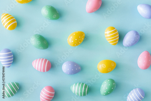 Flat lay set multi colored easter eggs on a pastel blue background top view