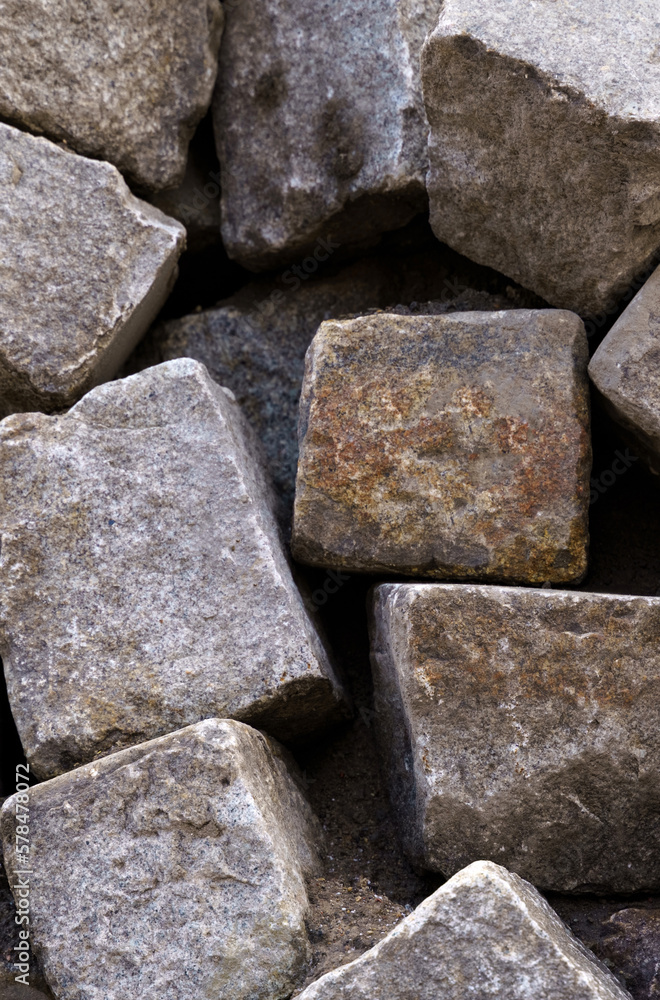 A pile of old large gray stone blocks. A pile of old large gray stone blocks.
