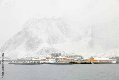 Reine fishing village on Lofoten islands with red rorbu houses in winter with snow. Lofoten islands, Norway, Europe © Rechitan Sorin