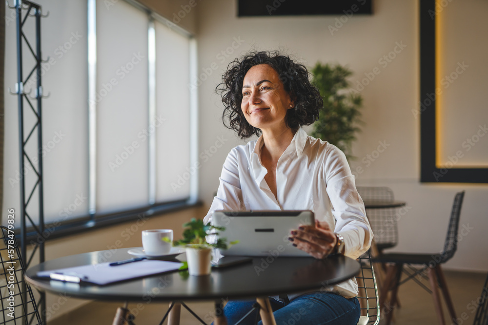 One woman mature female entrepreneur use digital tablet for work One woman mature female entrepreneur use digital tablet for work