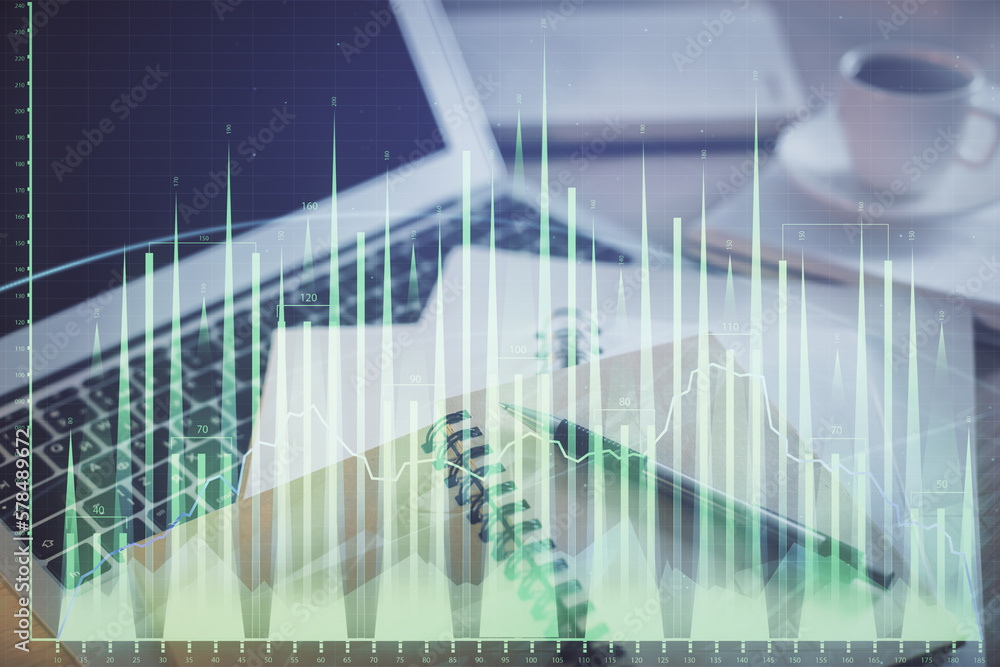 Double exposure of financial chart drawing and desktop with coffee and items on table background. Concept of forex market trading Double exposure of financial chart drawing and desktop with coffee and items on table background. Concept of forex market trading