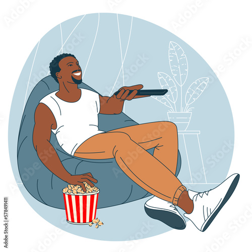 Man with popcorn is watching TV