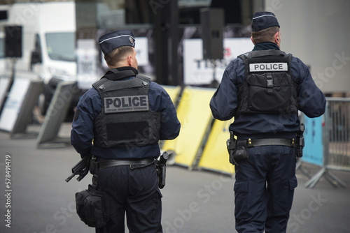 Fototapeta Naklejka Na Ścianę i Meble -  View of policemen walking in the street